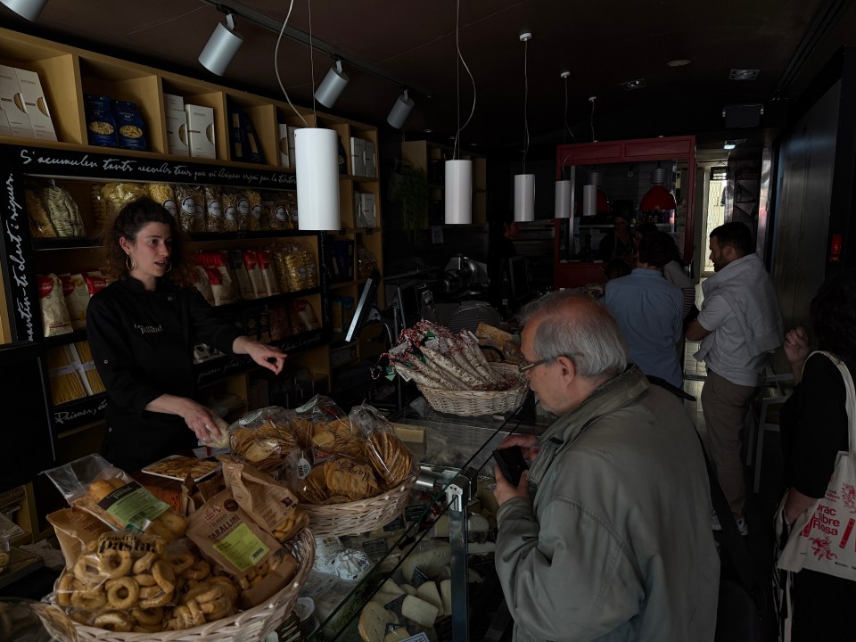 Customers at a Barcelona food shop during a power outage.