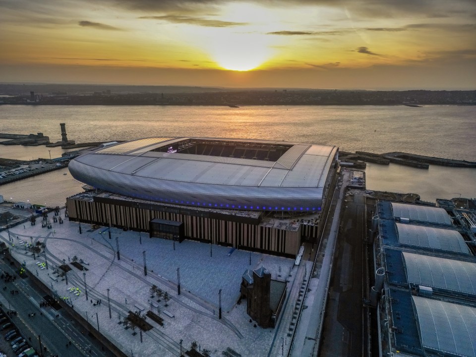 Aerial view of Everton's new stadium at Bramley-Moore Dock in Liverpool at sunset.