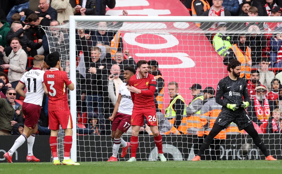Liverpool's Andrew Robertson looks dejected after scoring an own goal.