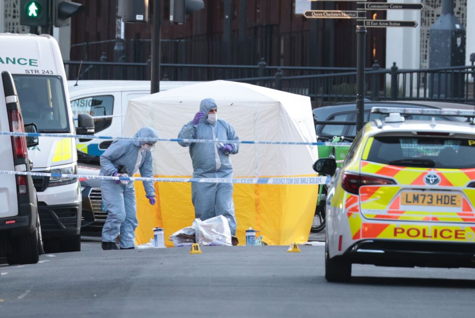 Forensic officers at a London crime scene.