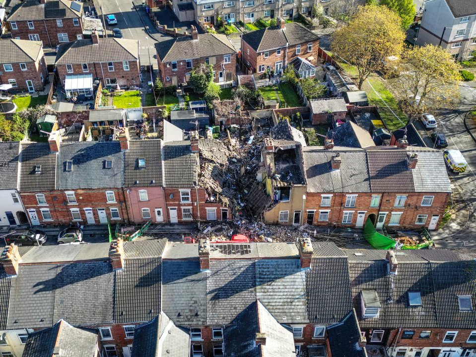 Aerial view of emergency responders at the site of a house explosion.