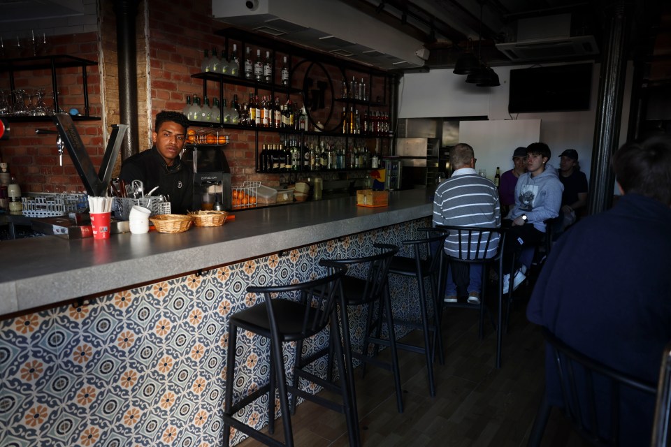 Bar patrons seated at a bar during a blackout.