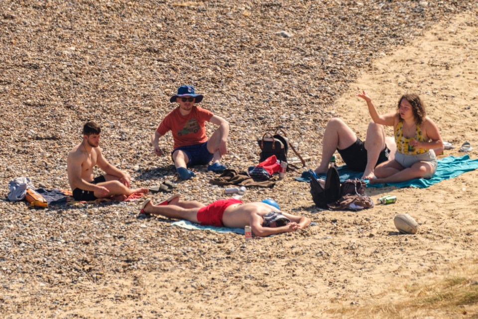 People relaxing on a pebble beach.