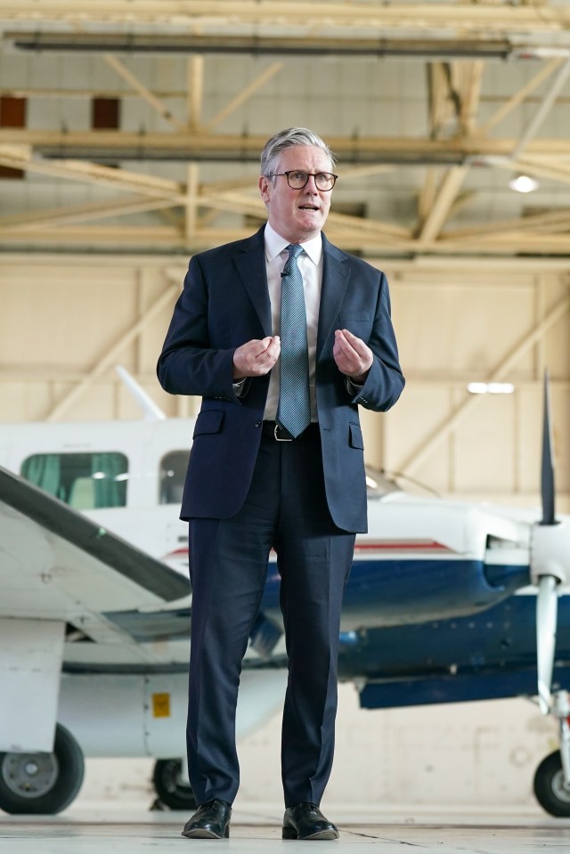 Prime Minister Keir Starmer speaking in front of a plane.