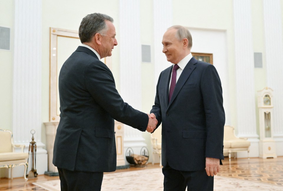 Vladimir Putin and Steve Witkoff shaking hands.