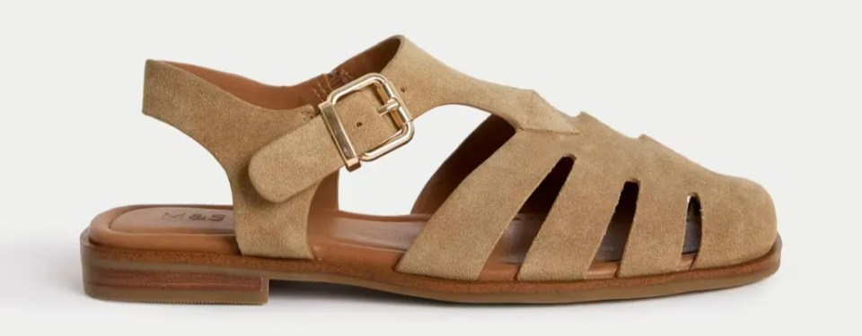 Beige suede fisherman sandals with a buckle.