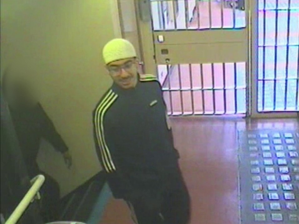 Security camera image of Hashem Abedi in an Adidas tracksuit and glasses leaving a prison lobby.