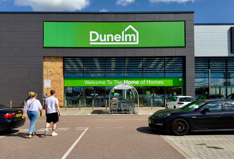 Dunelm store exterior with customers in the parking lot.