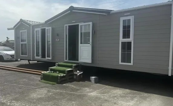 Photo of a gray mobile home after renovations.