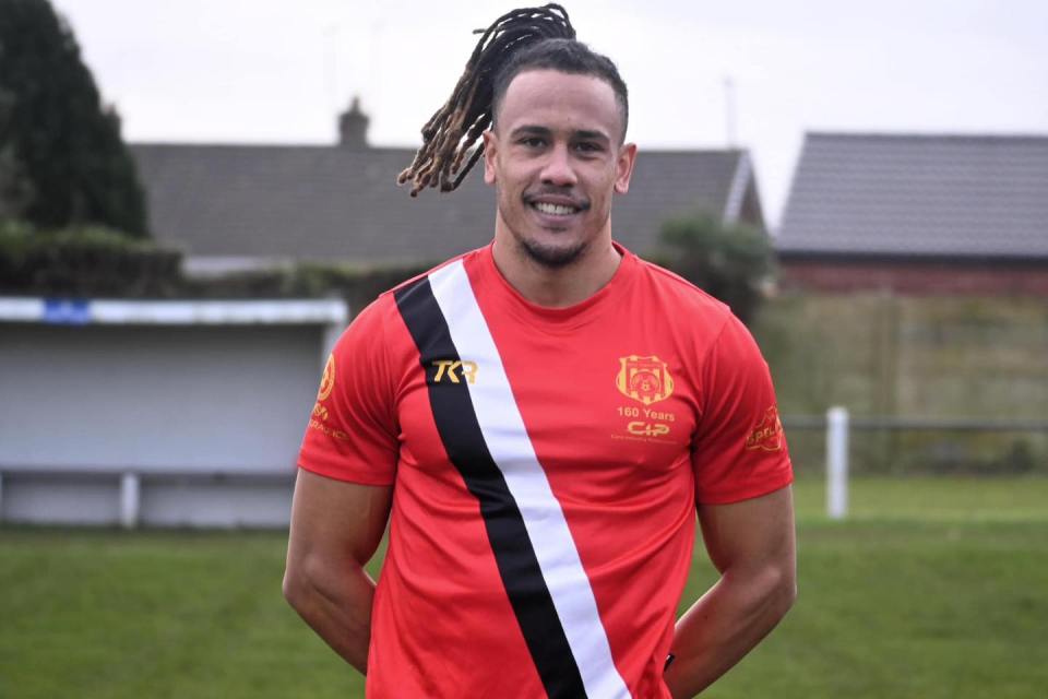 Man in red rugby shirt.
