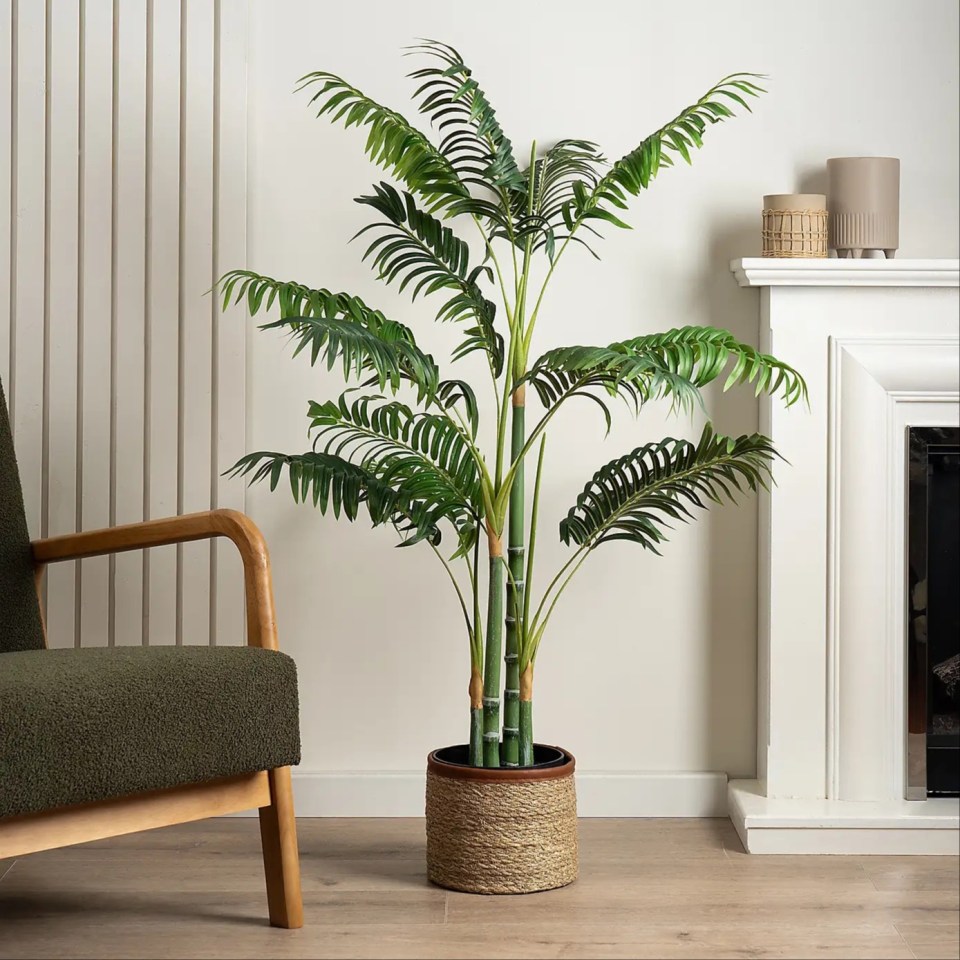 Artificial golden palm tree in a woven pot.