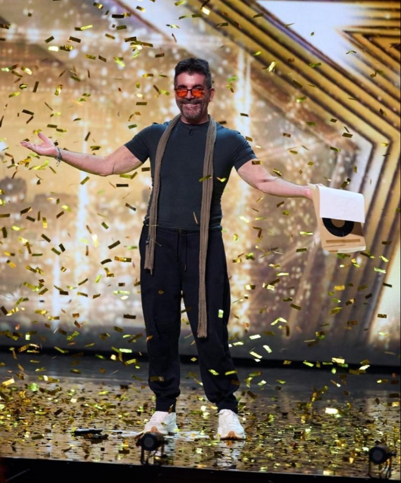 Simon Cowell receiving a Golden Buzzer amidst falling confetti.