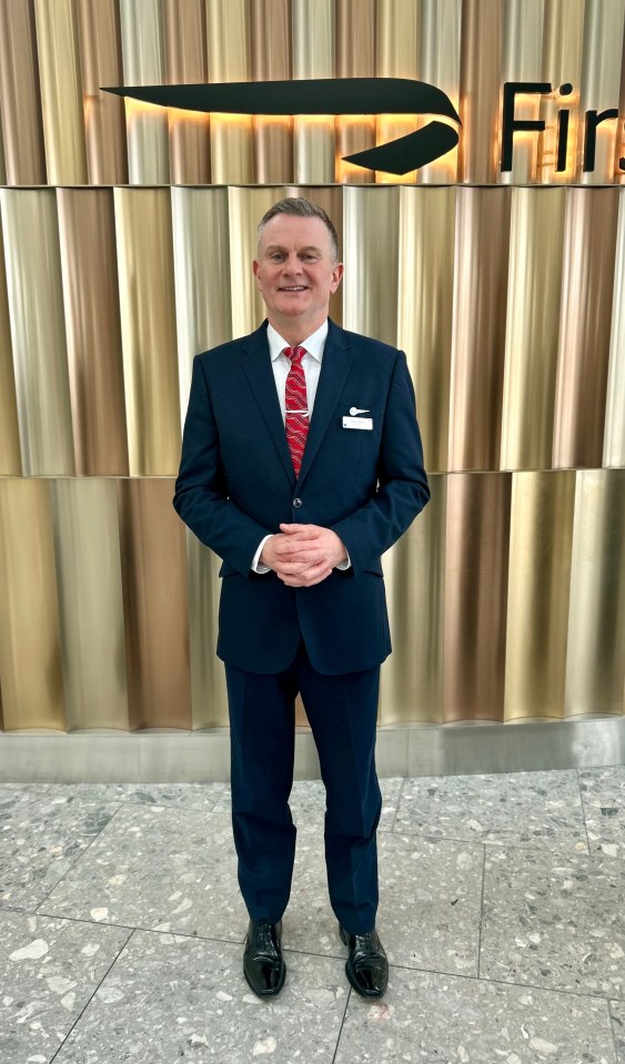 British Airways First Class employee in uniform.