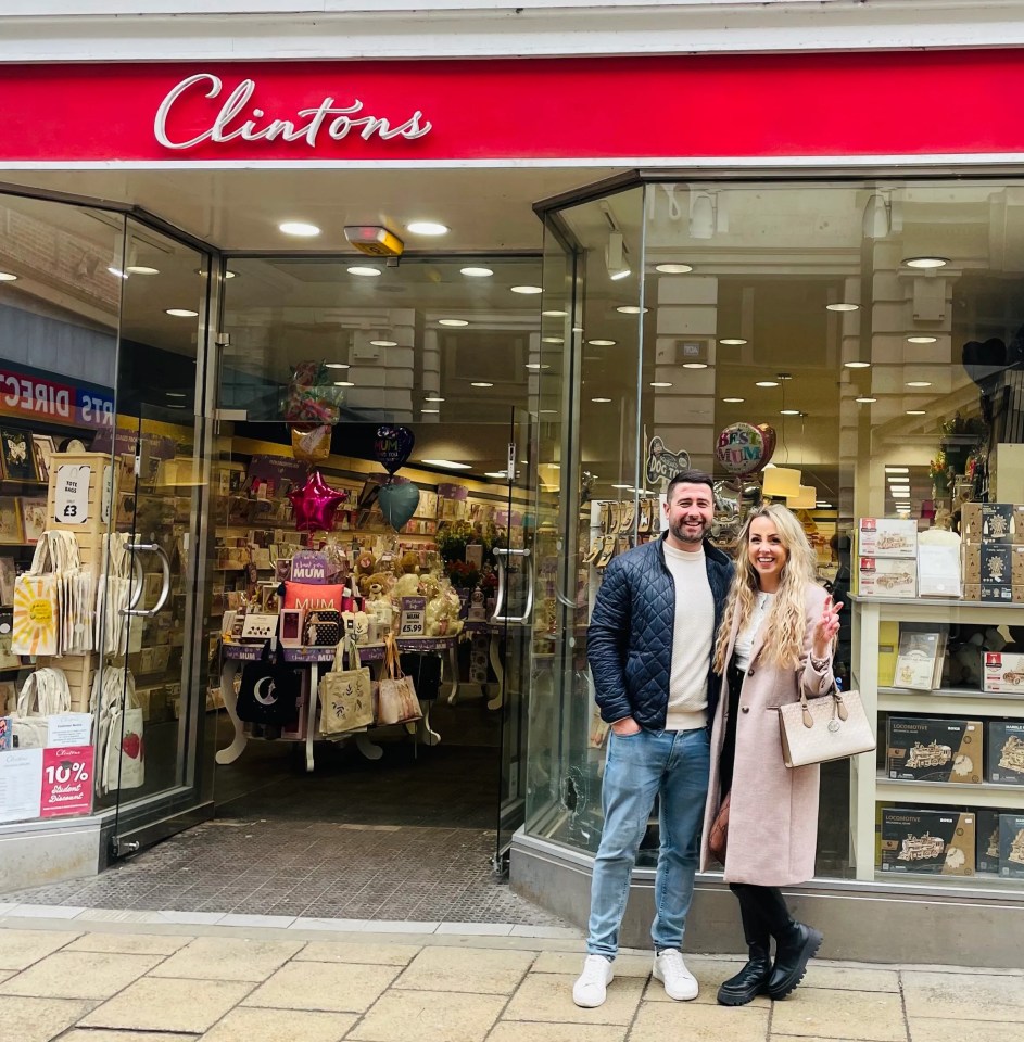 Couple standing in front of a Clinton's store.