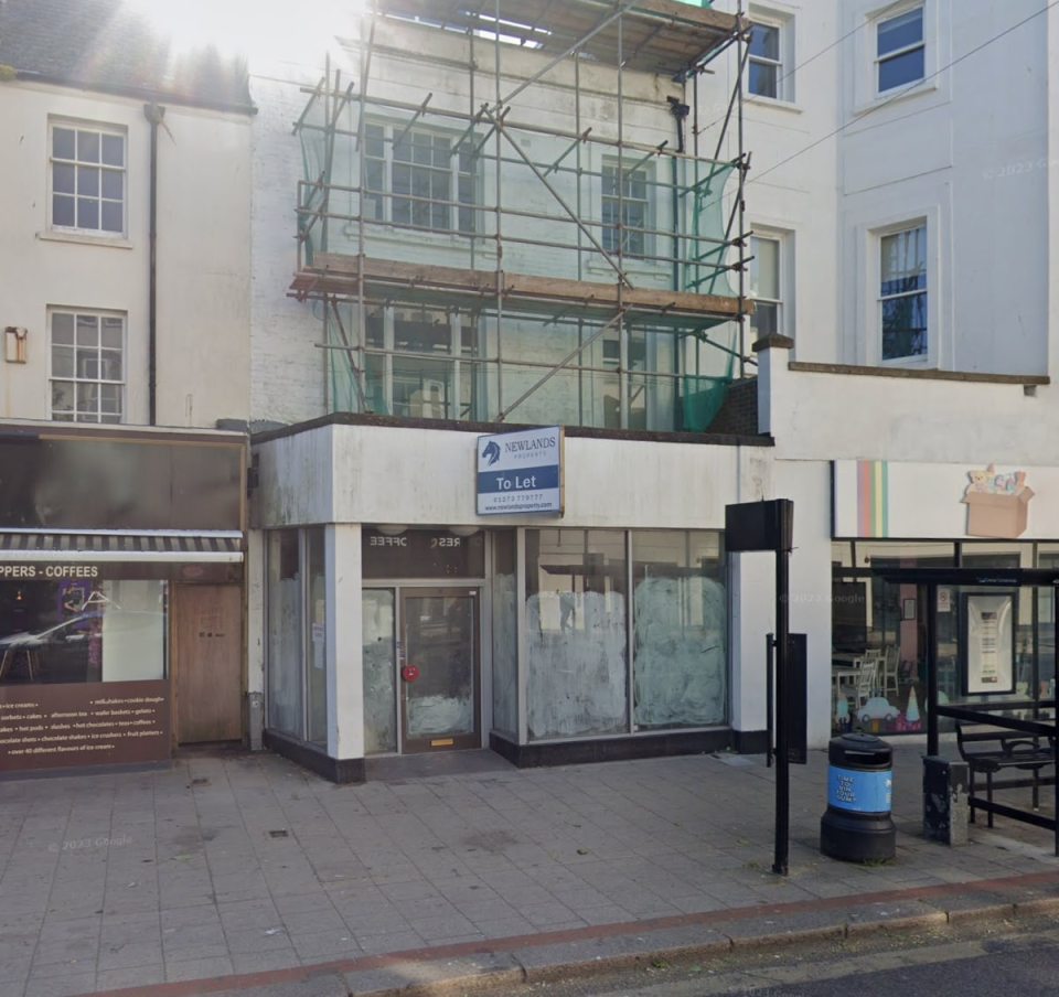 Empty storefront with "To Let" sign.