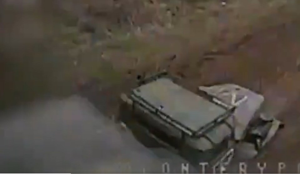 Blurry security camera image of a vehicle in a ditch.