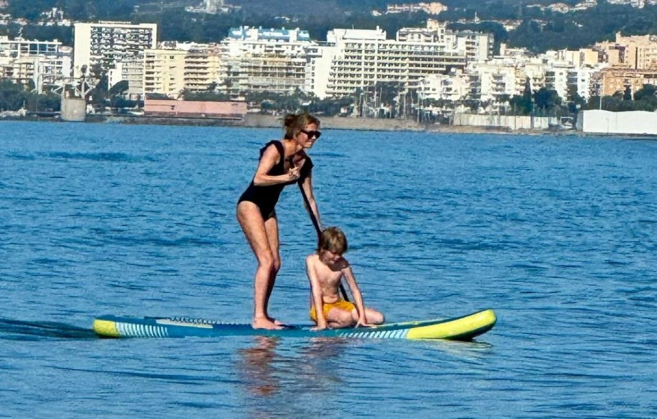 Woman and child paddleboarding.