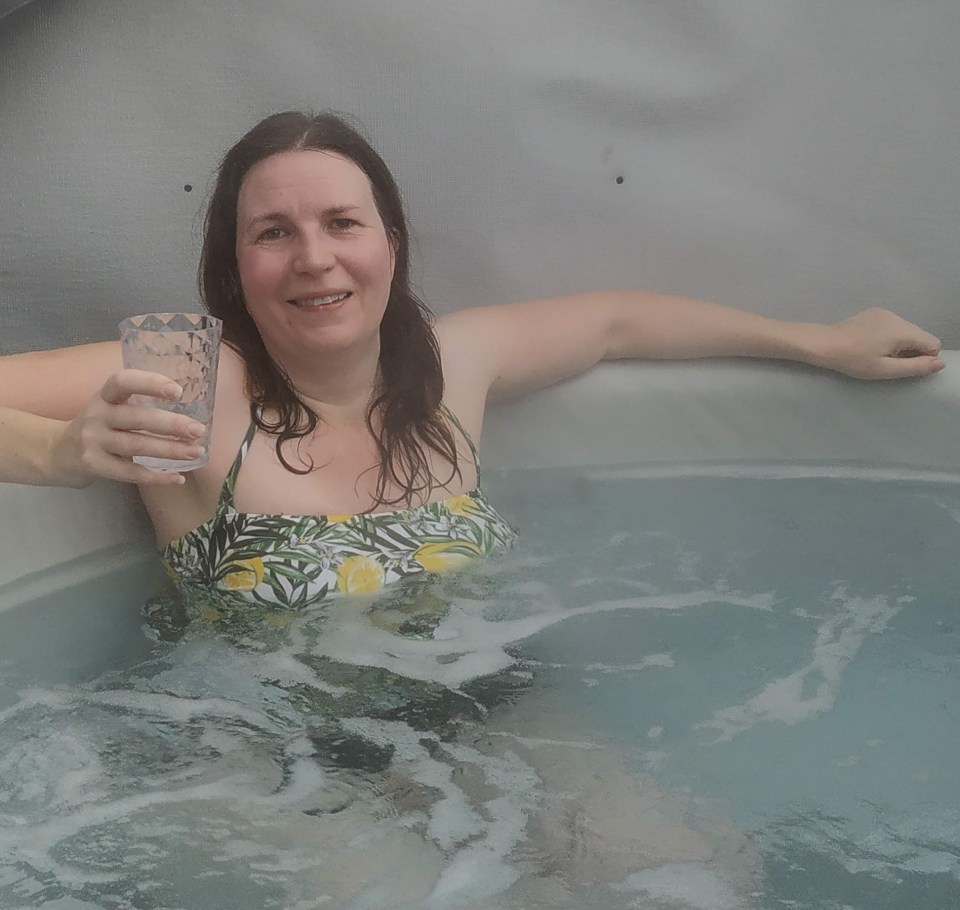 Woman relaxing in a hot tub.