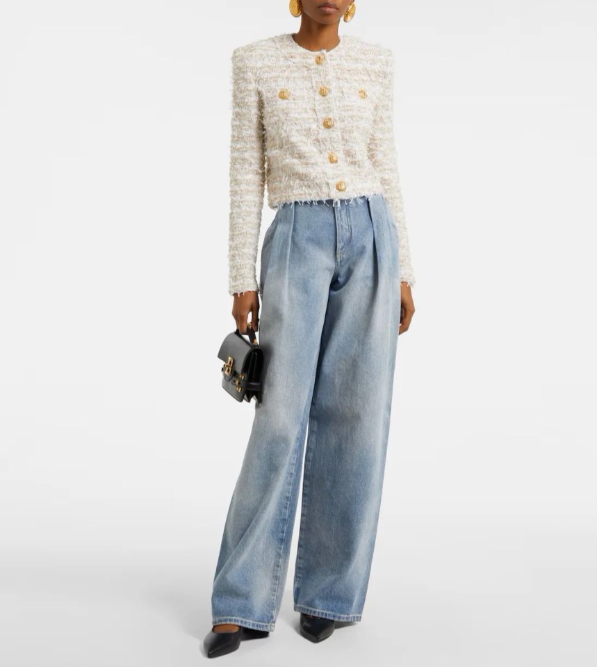 Model wearing a Balmain cropped tweed jacket and wide-leg jeans.