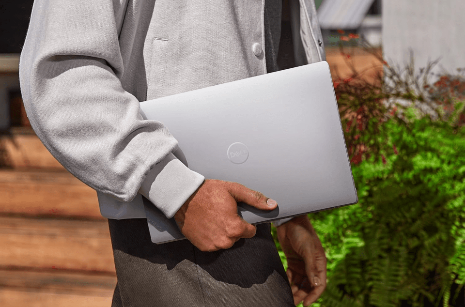 Person carrying a Dell laptop.