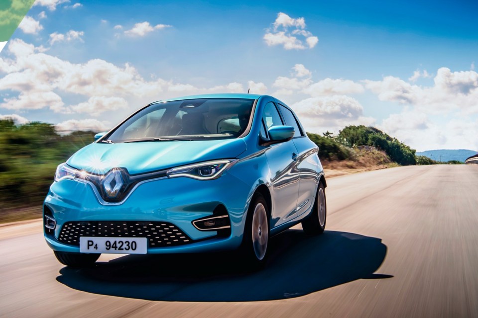 A blue Renault Zoe electric car driving on a road.