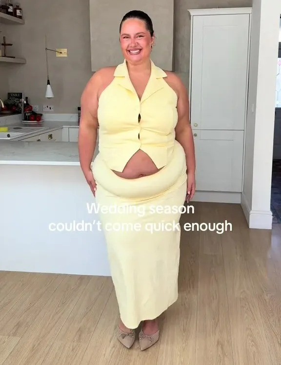 Woman in a pale yellow two-piece outfit.