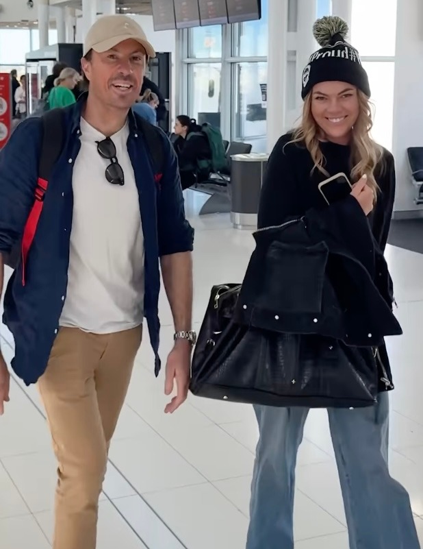 Couple walking through an airport.