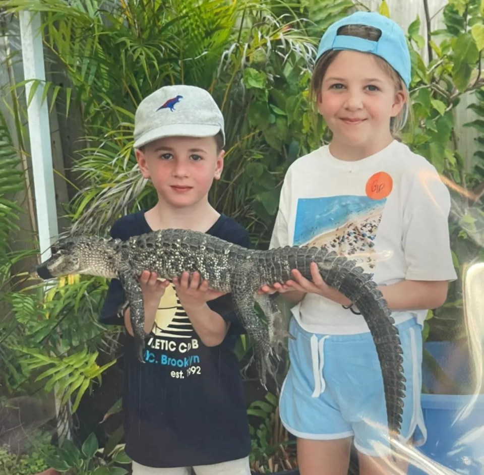 Two children holding a small alligator at the Everglades.