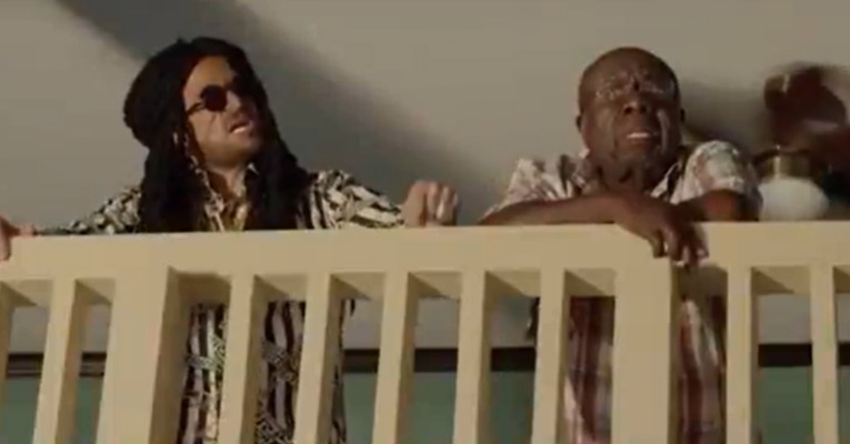 Peter Andre in a movie scene wearing a dreadlock wig.