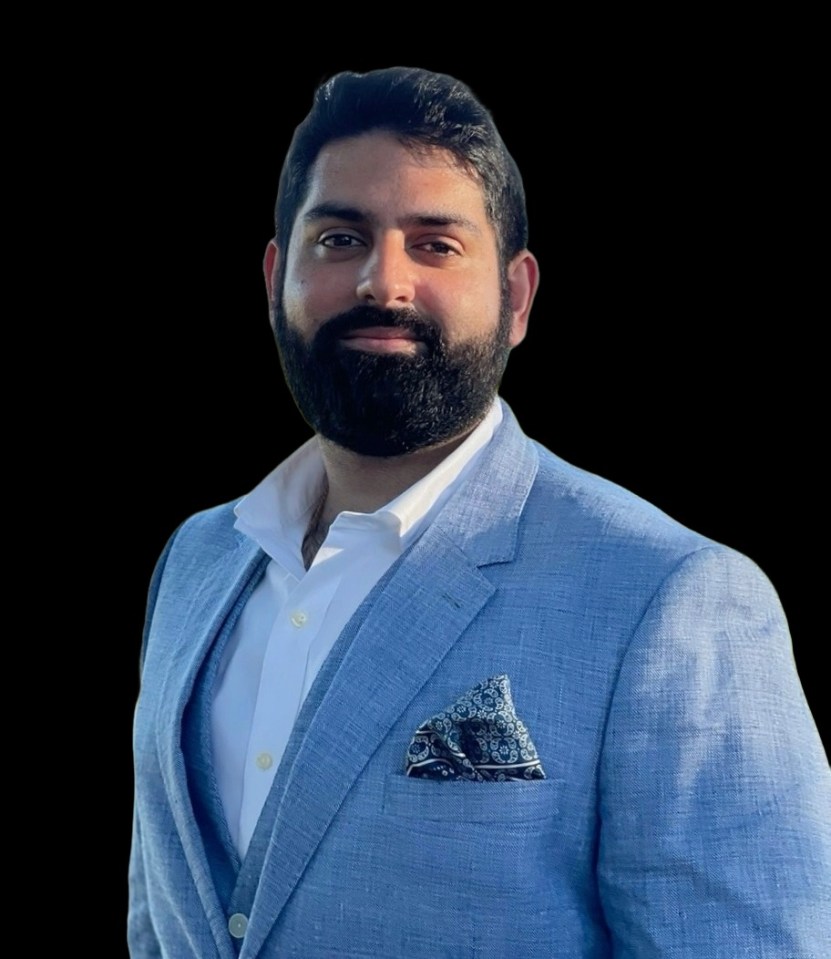 Headshot of a man in a light blue suit.