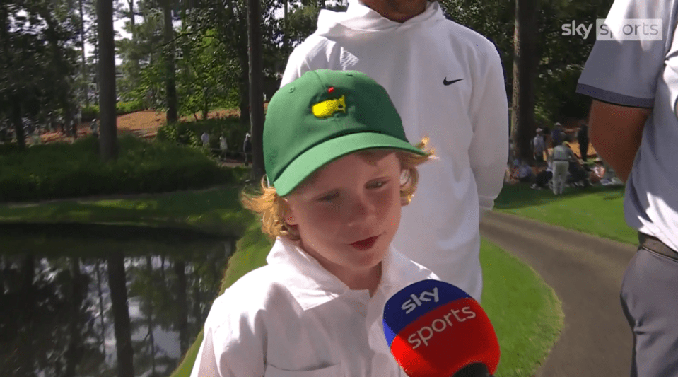 Young boy in a green golf cap being interviewed by Sky Sports.