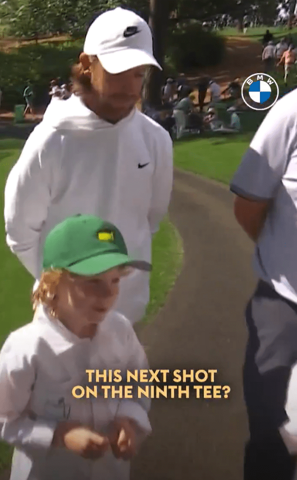 A man and child on a golf course.