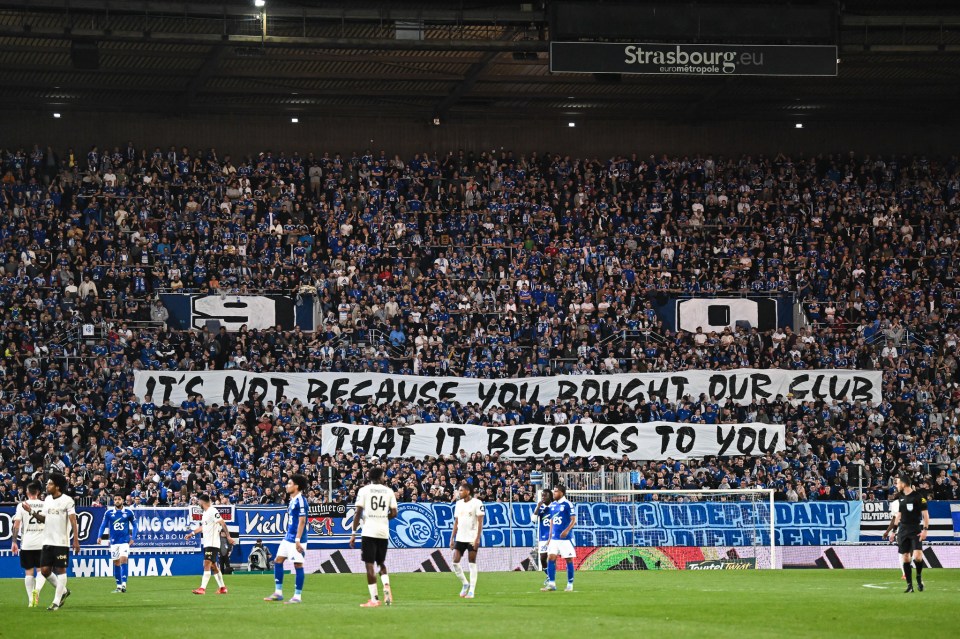 Stadium crowd holding a banner that reads "It's not because you bought our club that it belongs to you".