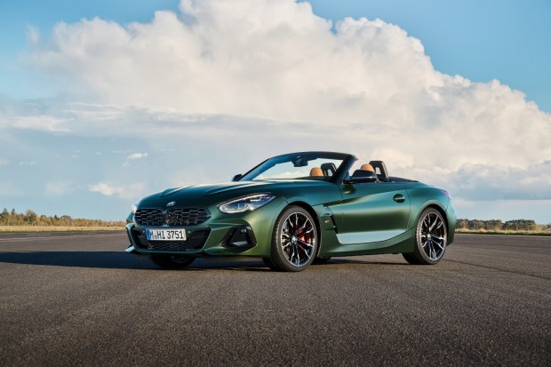 Green BMW Z4 convertible parked on a tarmac.