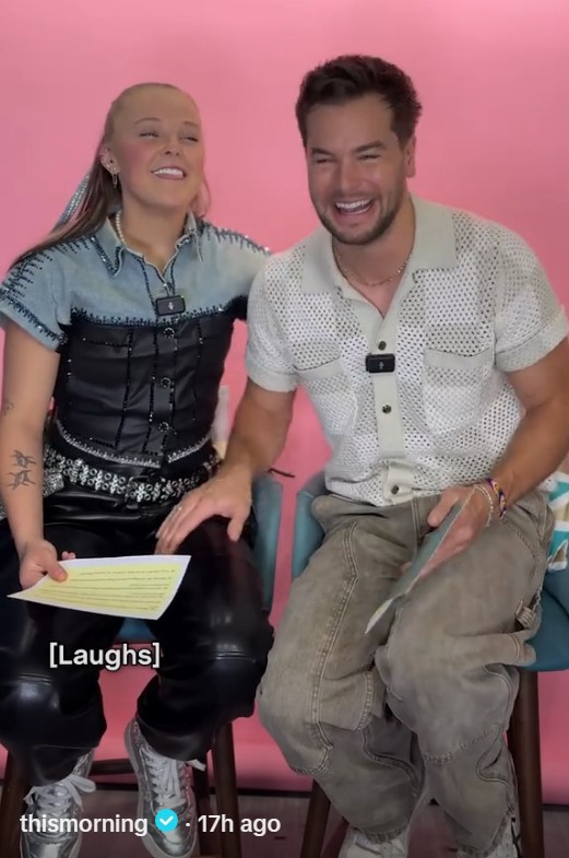 JoJo Siwa and Chris Hughes laughing together.