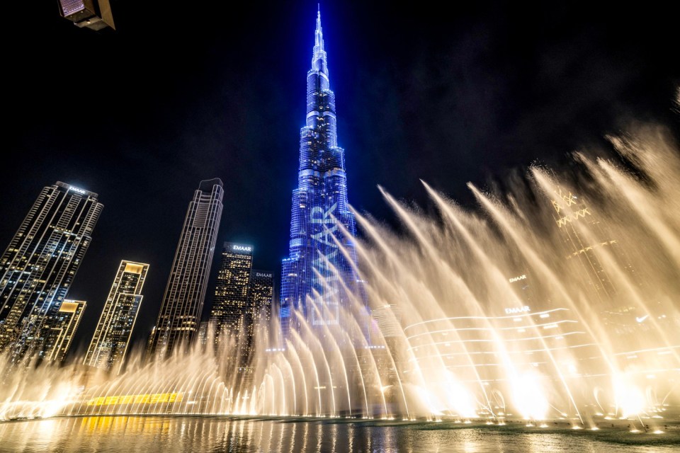 Fountains spray water beneath Burj Khalifa, the world's tallest building, ahead of New Year's Eve celebrations in Dubai on December 31, 2024. (Photo by FADEL SENNA / AFP) (Photo by FADEL SENNA/AFP via Getty Images)