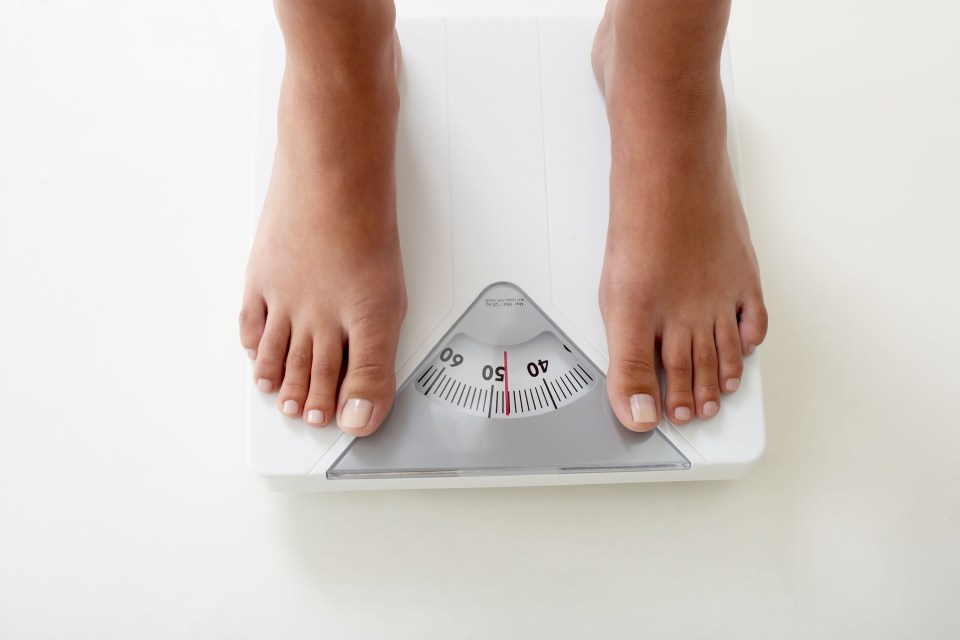 Person's feet on a scale.