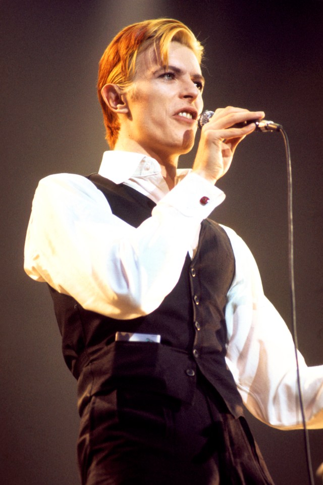 David Bowie performing on stage.