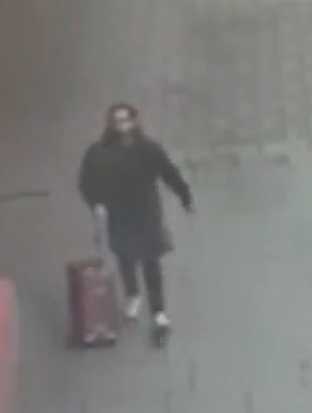Person pulling a suitcase.