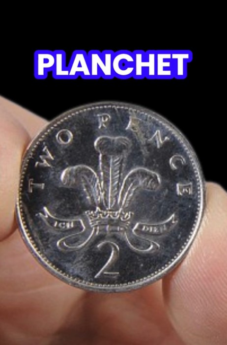 Close-up of a two pence coin with the word "PLANCHET" above it.