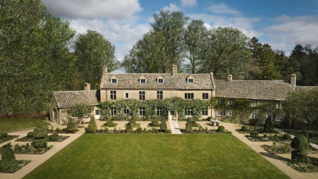 Aerial view of a Cotswolds manor house with manicured gardens.