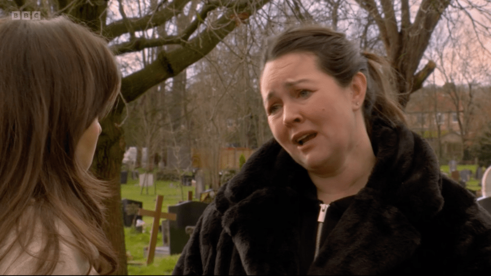 Screenshot of two women in a cemetery, one visibly upset.