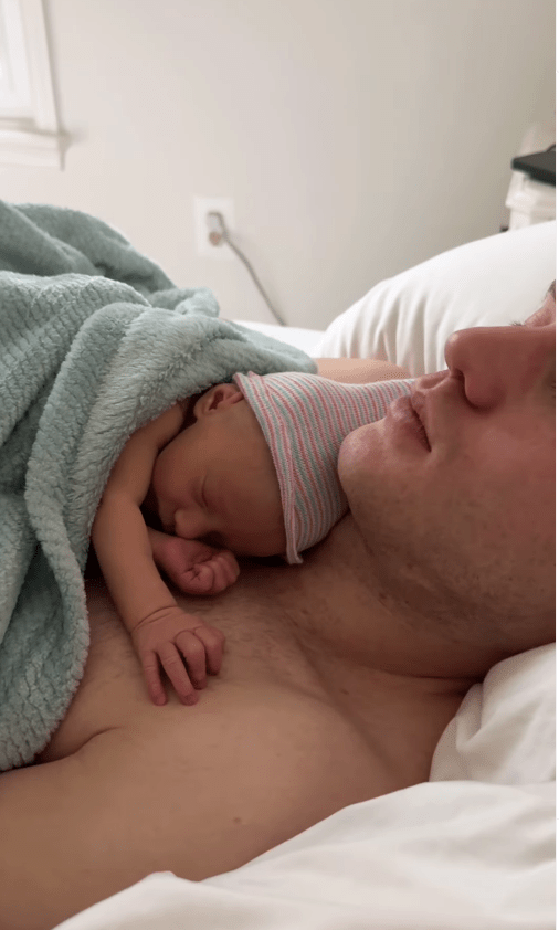 Newborn sleeping on father's chest.
