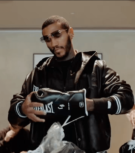 Man putting on boxing gloves.