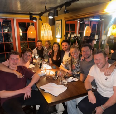 Group of friends sitting at a restaurant table.
