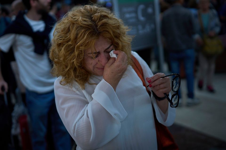 Paquita Gonzalez cries as she waits for news of train departures, after spending the whole night at the station Sants station in Barcelona, Spain, Tuesday, April 29, 2025. (AP Photo/Emilio Morenatti)