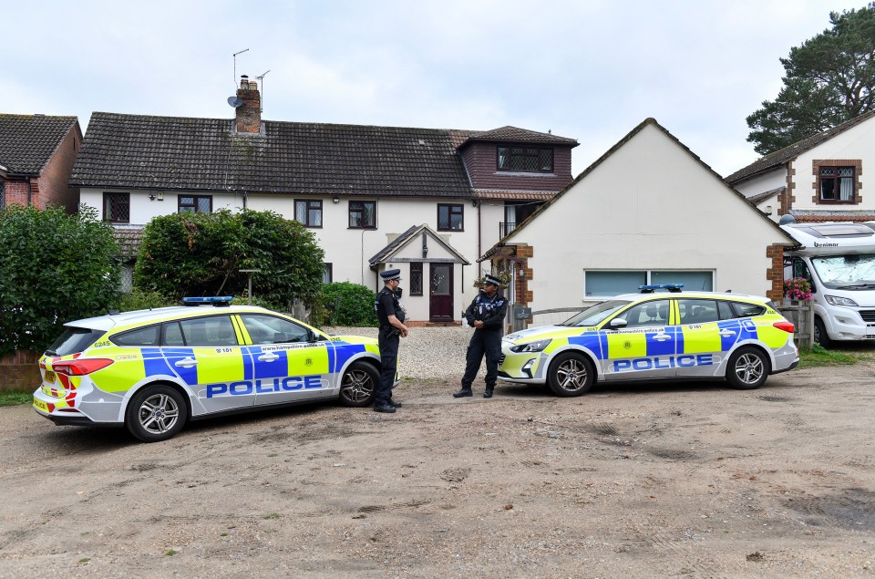 Police cars parked outside a house.