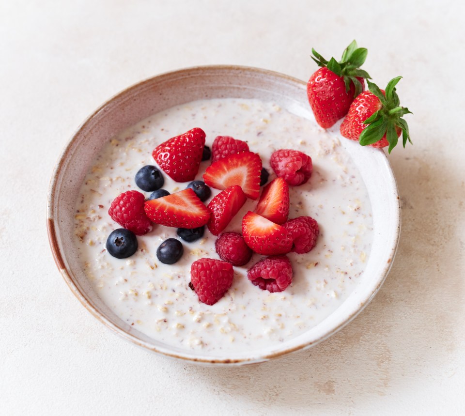 Oatmeal topped with strawberries, raspberries, and blueberries.