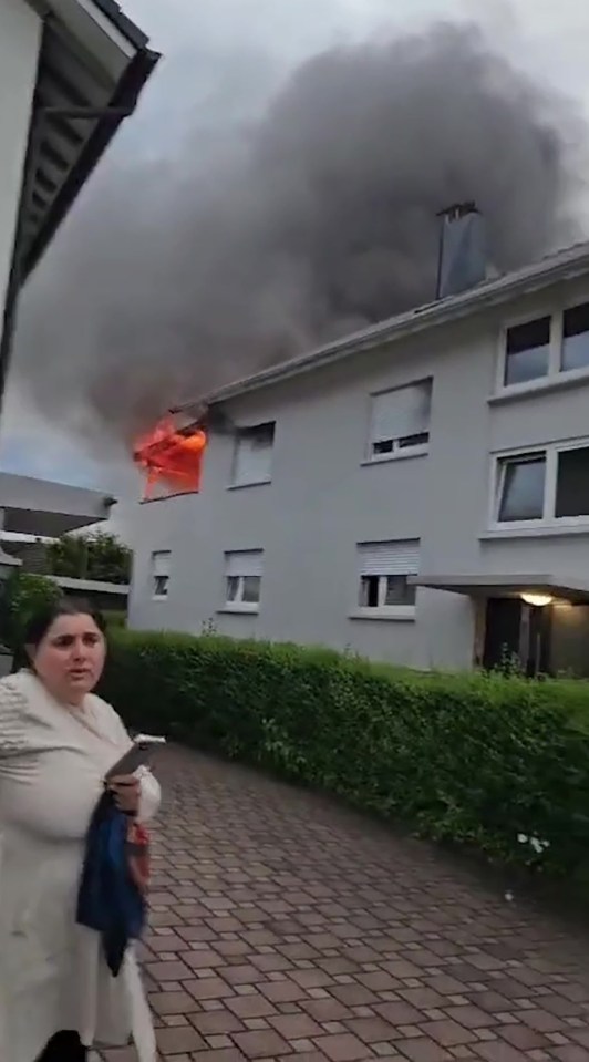 Man escaping burning building by jumping onto a trampoline.