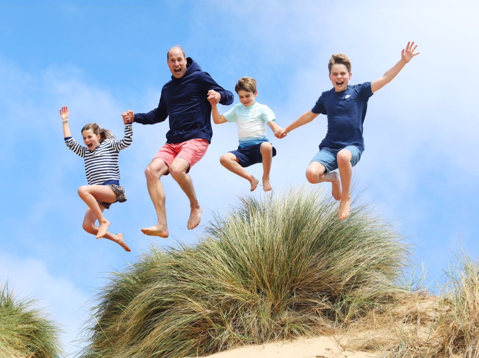 Prince William jumping for joy with his three children.